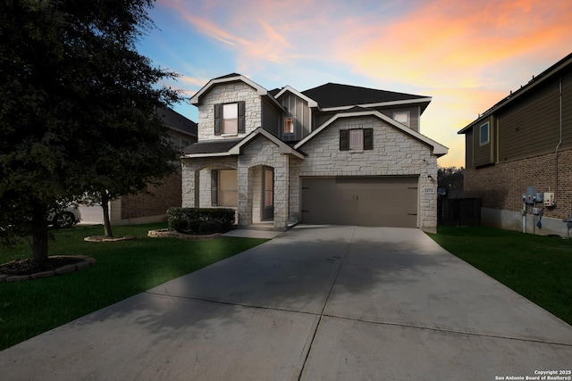 craftsman-style home featuring an attached garage, driveway, stone siding, a front lawn, and board and batten siding