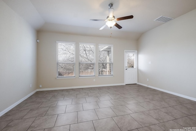 empty room featuring baseboards, visible vents, vaulted ceiling, and a ceiling fan