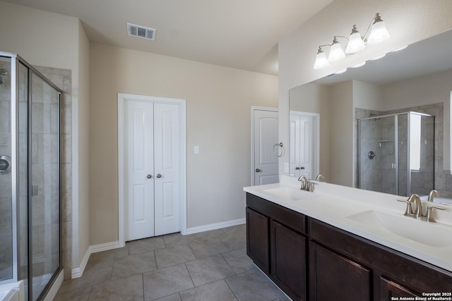 bathroom with a stall shower, visible vents, a sink, and tile patterned floors