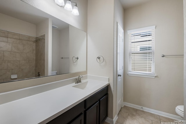 full bathroom with vanity, tile patterned flooring, toilet, and baseboards