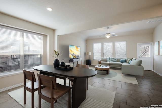 dining room featuring a wealth of natural light, tile patterned flooring, and visible vents