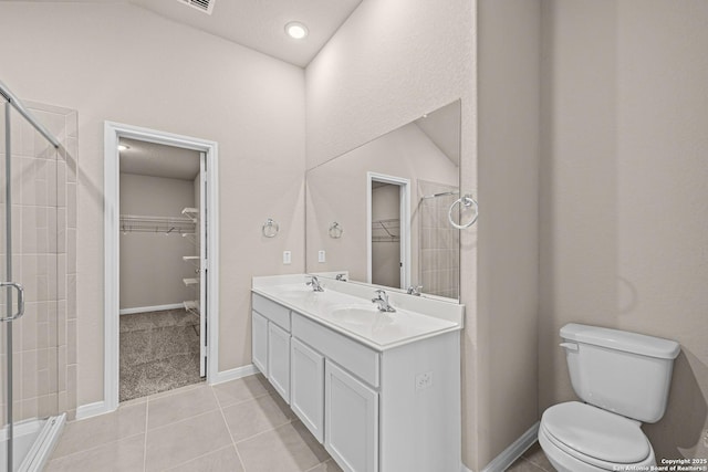 8421 Roadrunner Psge, San Antonio, TX 78222 - bathroom with a spacious closet, a stall shower, toilet, and double vanity