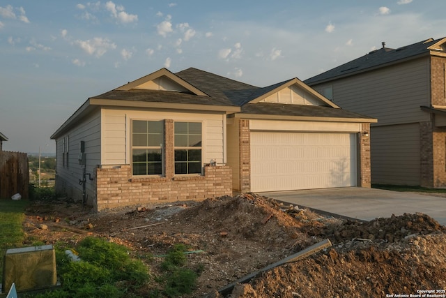 8421 Roadrunner Psge, San Antonio, TX 78222 - view of front facade with a garage, driveway, brick siding, and a shingled roof