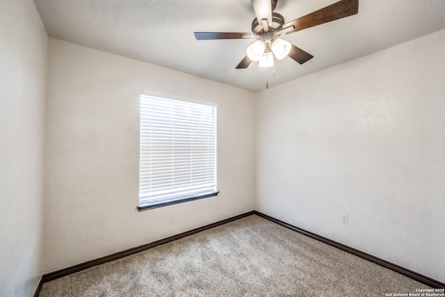 carpeted empty room featuring a ceiling fan and baseboards