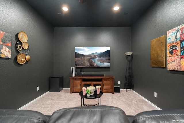 home theater room with a textured wall, recessed lighting, baseboards, and light colored carpet