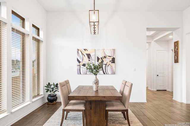 dining space featuring plenty of natural light, wood finished floors, and baseboards