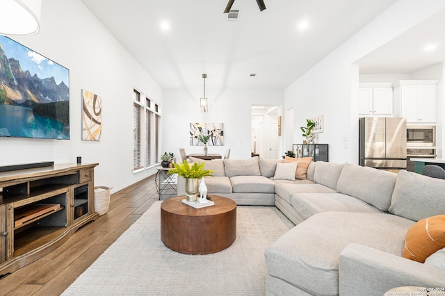 living room featuring light wood finished floors and visible vents