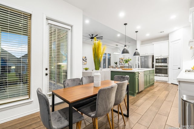 dining space with light wood-style floors, ceiling fan, visible vents, and recessed lighting