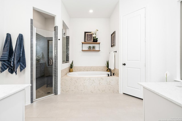 bathroom featuring a stall shower, vanity, and a bath