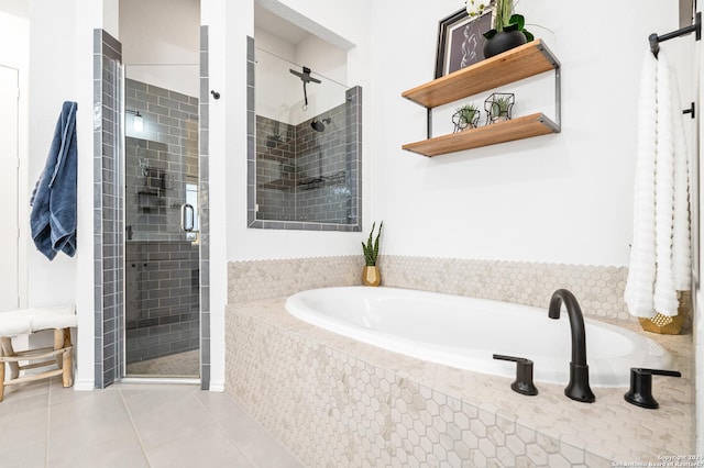 full bathroom with tile patterned flooring, a shower stall, and a bath