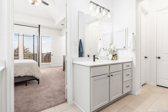 ensuite bathroom with a ceiling fan, tile patterned flooring, vanity, and ensuite bath