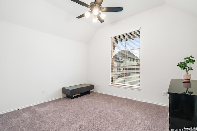 spare room with a ceiling fan, lofted ceiling, carpet flooring, and baseboards