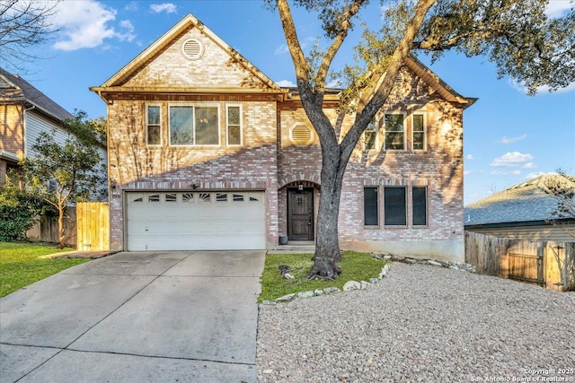 view of front of house featuring brick siding, driveway, an attached garage, and fence