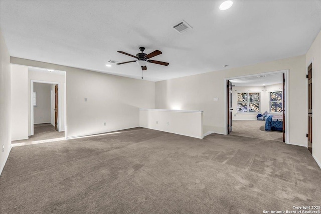 spare room with a ceiling fan, light colored carpet, visible vents, and recessed lighting