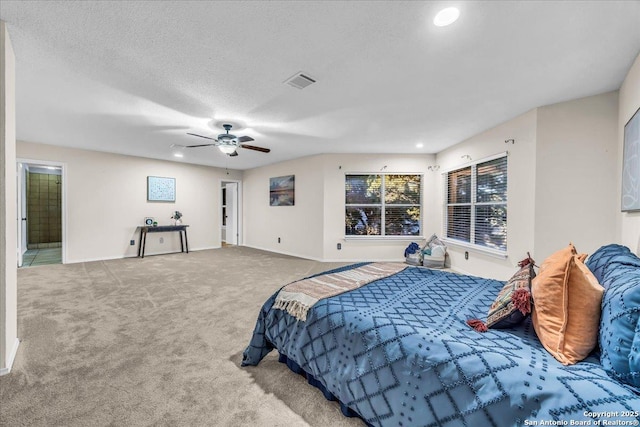 bedroom with carpet floors, visible vents, a ceiling fan, a textured ceiling, and baseboards