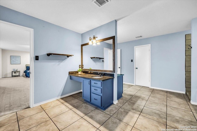 bathroom featuring baseboards, visible vents, and tile patterned floors