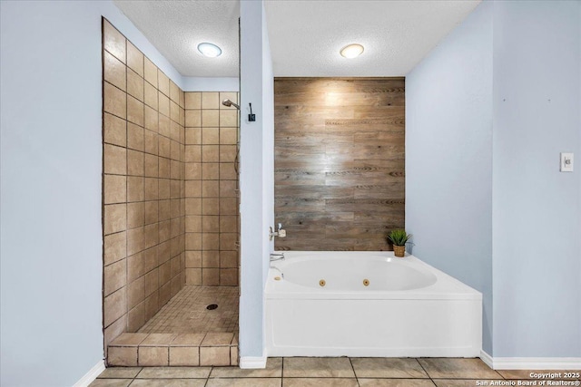 bathroom featuring a stall shower, baseboards, a tub with jets, tile patterned floors, and a textured ceiling