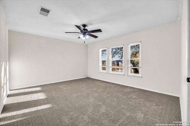 empty room with baseboards, visible vents, ceiling fan, and carpet flooring