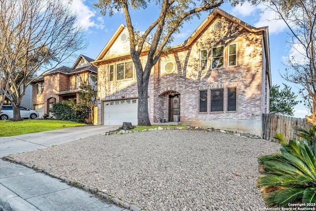 view of front facade featuring concrete driveway, brick siding, fence, and an attached garage