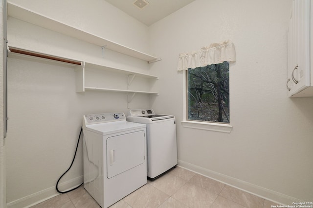 washroom with cabinet space, visible vents, baseboards, and washer and dryer