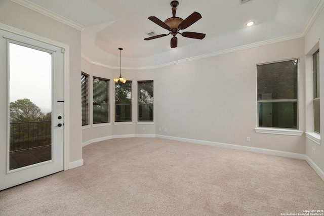 empty room featuring ornamental molding, light carpet, baseboards, and ceiling fan with notable chandelier