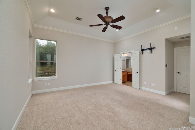 unfurnished bedroom featuring light carpet, visible vents, baseboards, ensuite bath, and crown molding