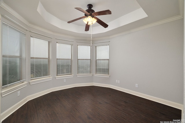 unfurnished room featuring ceiling fan, baseboards, a raised ceiling, and wood finished floors