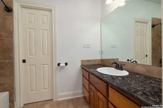 bathroom with vanity, baseboards, and tile patterned floors