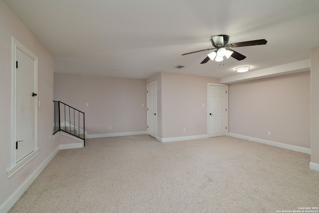 unfurnished room featuring light carpet, stairs, visible vents, and baseboards