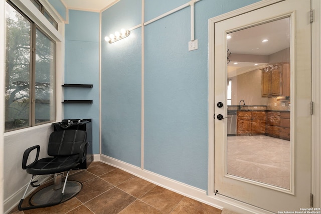 bathroom with tile patterned flooring, baseboards, and a sink