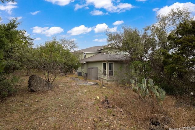 back of house featuring central AC