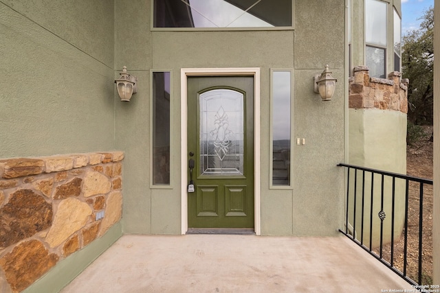 doorway to property featuring stucco siding