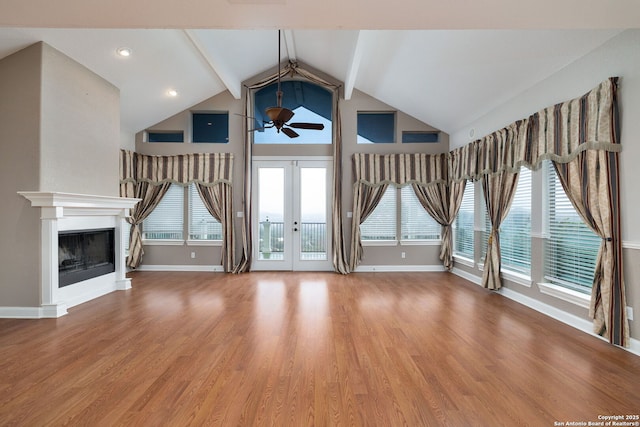 unfurnished living room featuring a fireplace, wood finished floors, a ceiling fan, and baseboards