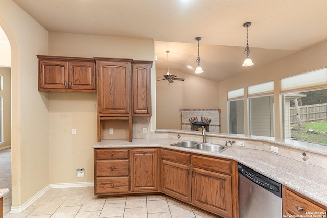 kitchen featuring arched walkways, brown cabinets, decorative light fixtures, a sink, and dishwasher