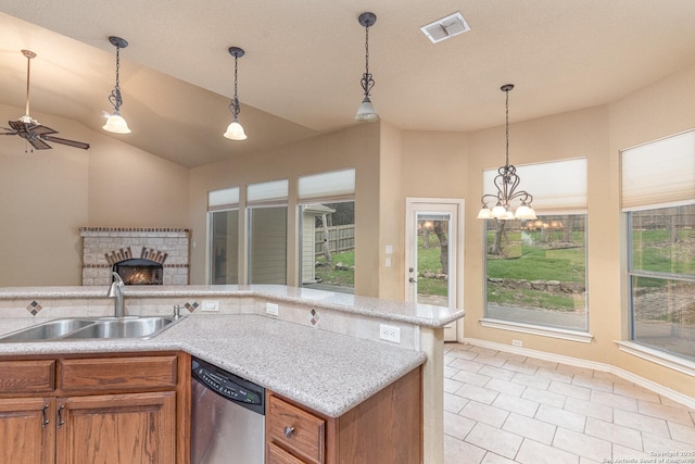 kitchen with a fireplace, a sink, visible vents, light countertops, and dishwasher