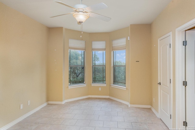 unfurnished room with ceiling fan and baseboards