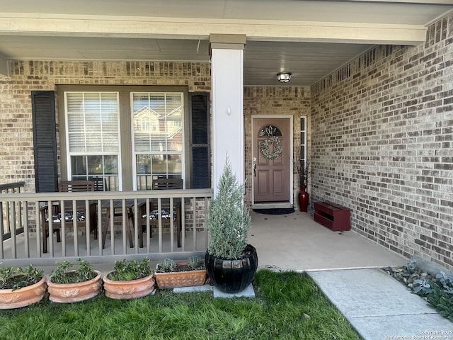 doorway to property with brick siding