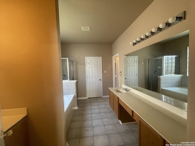 bathroom featuring a garden tub, a shower stall, vanity, and tile patterned floors