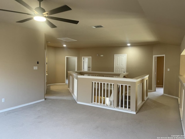 hallway with baseboards, visible vents, light colored carpet, an upstairs landing, and recessed lighting