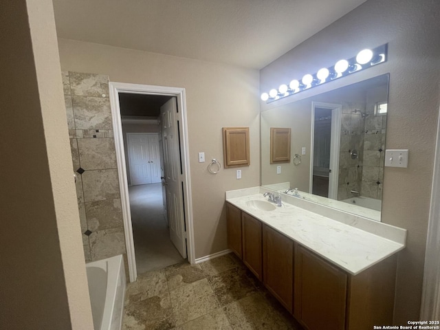 bathroom with stone finish floor, vanity, and baseboards