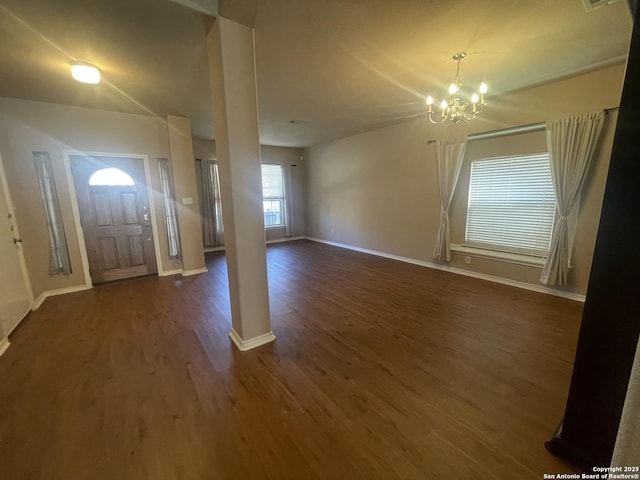 entrance foyer with baseboards, dark wood finished floors, and a notable chandelier