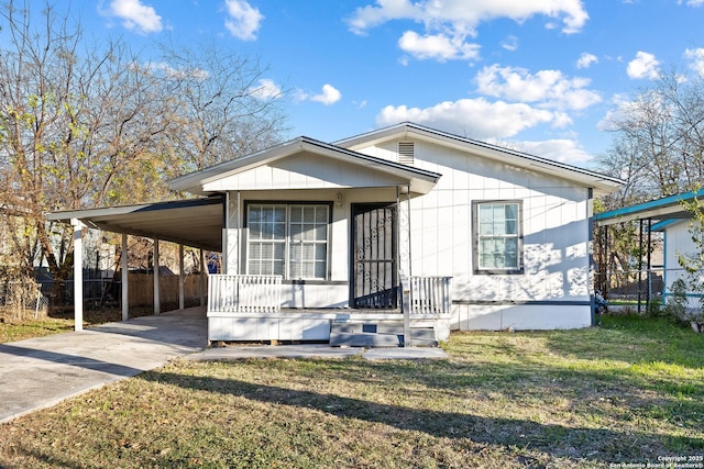 manufactured / mobile home with a carport, fence, and concrete driveway