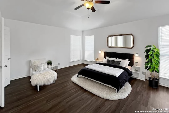 bedroom with dark wood-style flooring, ceiling fan, and baseboards