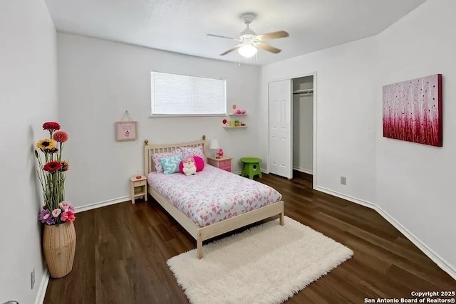 bedroom with ceiling fan, dark wood-style flooring, a closet, and baseboards