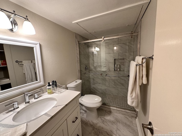 full bathroom with a textured ceiling, toilet, vanity, marble finish floor, and a stall shower