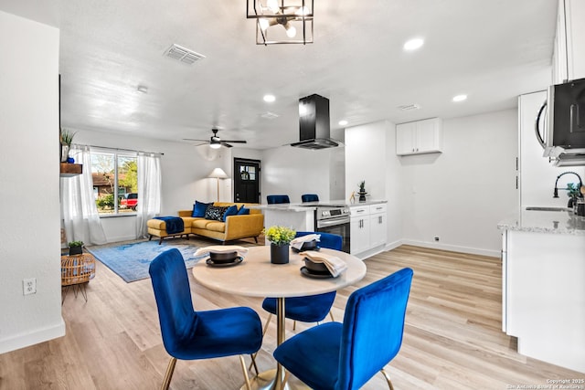 dining room with light wood-type flooring, visible vents, baseboards, and recessed lighting