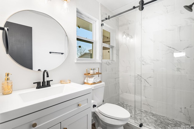 full bath with vanity, toilet, and a shower stall