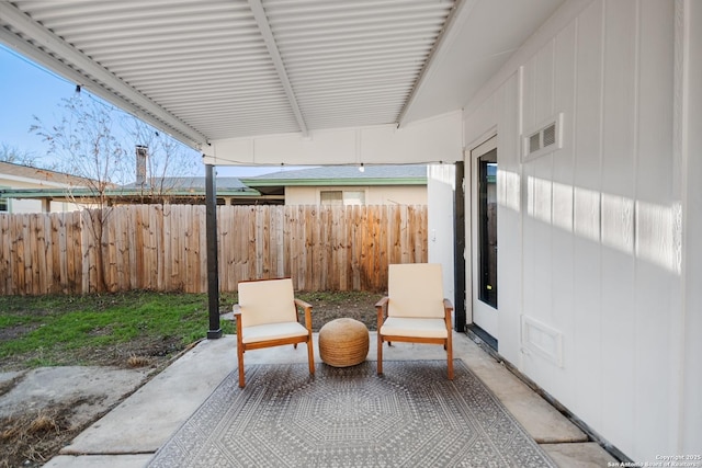 view of patio featuring fence and visible vents