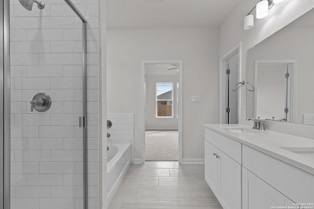 full bathroom with double vanity, a garden tub, a tile shower, and a sink