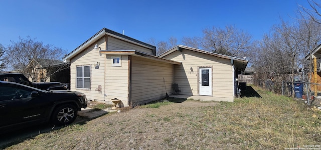 rear view of property with fence